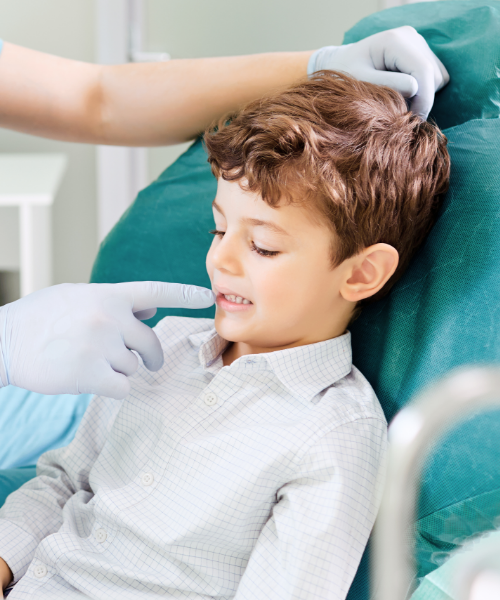 little boy receiving a dental exam in Dallas